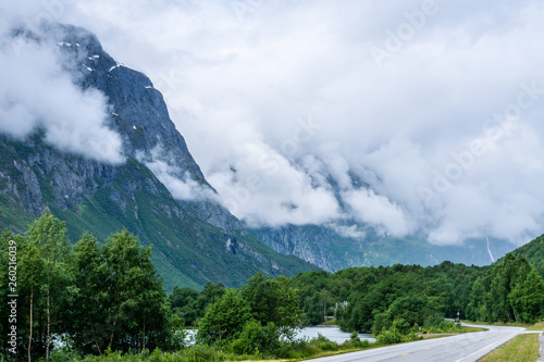 Road passing a large mountain peak in Norway