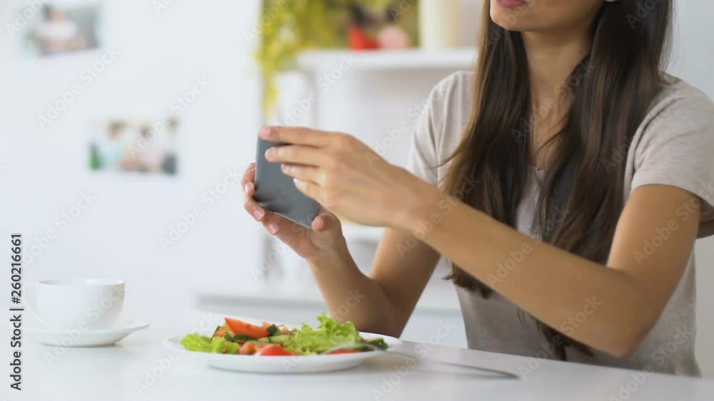 Girl making photos of vegetable salad before eating, food blogger, culinary tips Girl making photos of vegetable salad before eating, food blogger, culinary tips