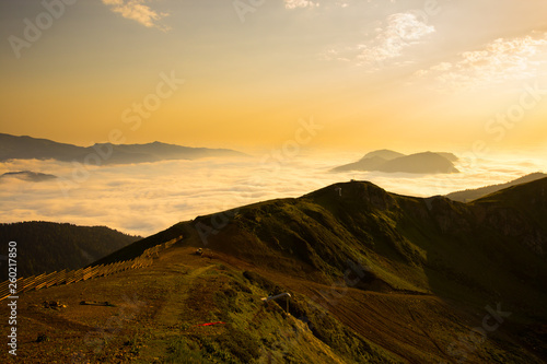 Stunning sunset in the Caucasian mountains above the clouds.