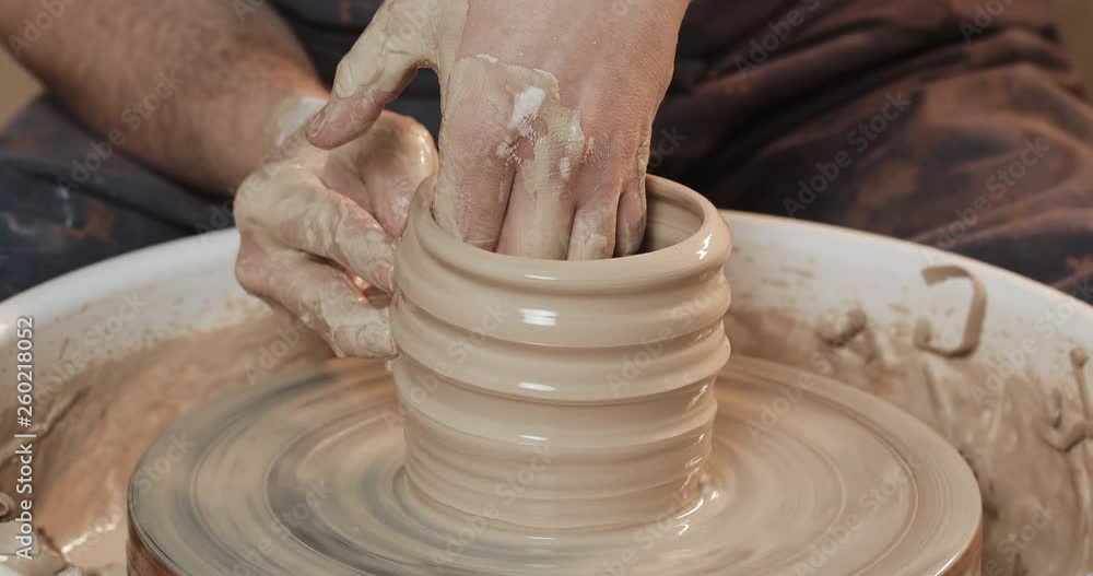 Hands of the master potter making ceramic products on the potter's wheel close-up. Handmade, craft Hands of the master potter making ceramic products on the potter's wheel close-up. Handmade, craft