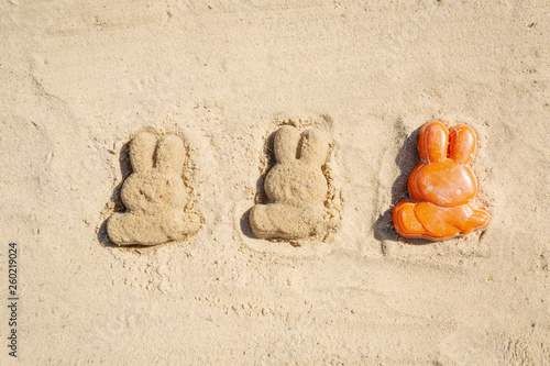 Child Easter concept on the warm sand photo