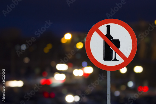 the Sign the prohibition of alcohol and the night road with cars