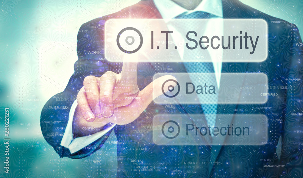 A business man selecting a button on a futuristic display with a I.T. Security concept written on it. A business man selecting a button on a futuristic display with a I.T. Security concept written on it.