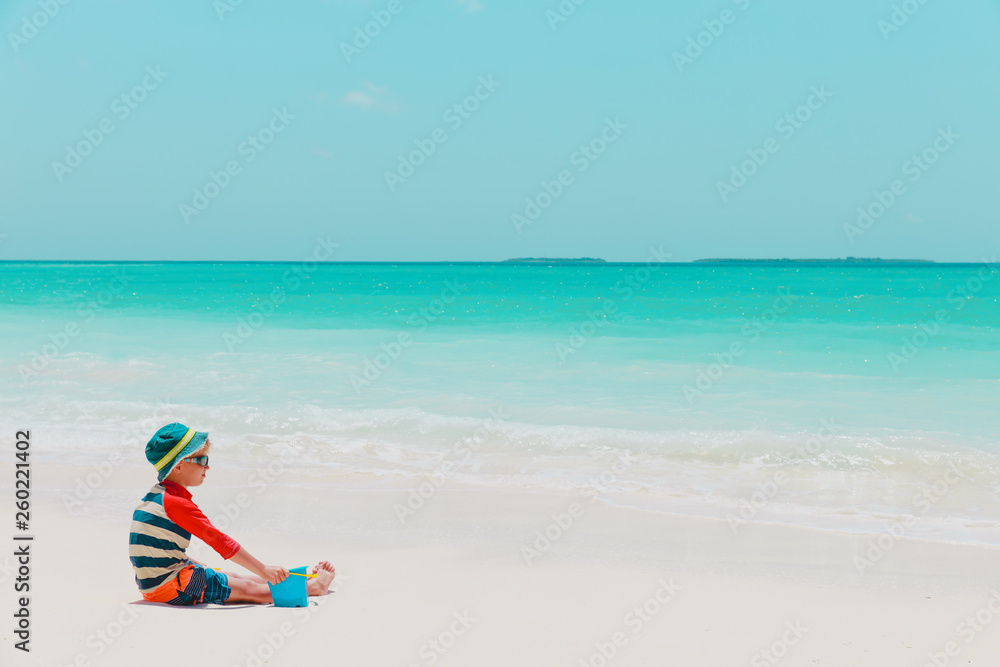 cute little boy play with water and sand on beach cute little boy play with water and sand on beach