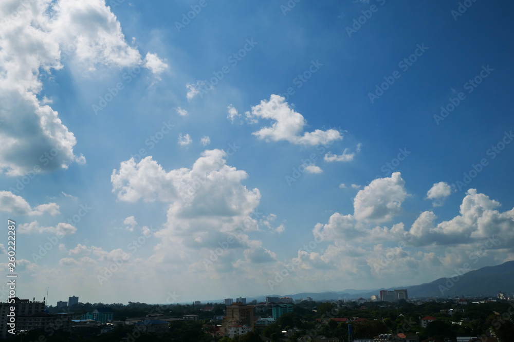 white cloud on clear blue sky above the town