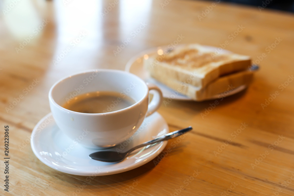 Hot coffee and American breakfast with sunny side up eggs, bacon, toast