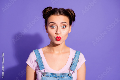 Close-up photo portrait of pretty attractive nice glad charming gorgeous she her student millennial sending kiss to you wearing cool outfit t-shirt isolated purple bright background