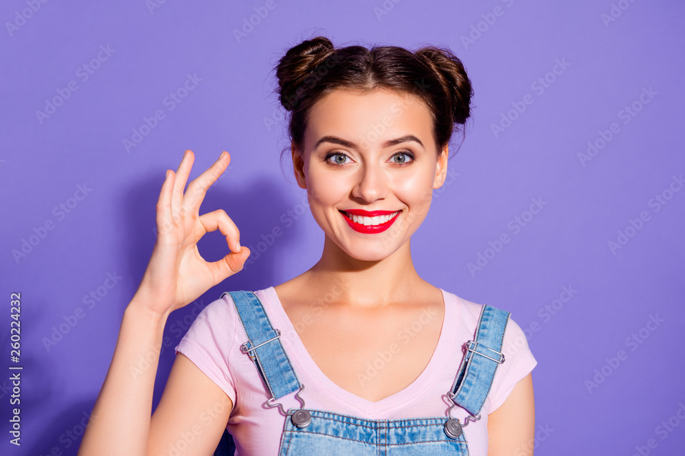Close up photo beautiful amazing she her lady buns show white teeth toothy hold arm hand okey symbol perfection wear casual t-shirt jeans denim overalls clothes isolated purple violet background Close up photo beautiful amazing she her lady buns show white teeth toothy hold arm hand okey symbol perfection wear casual t-shirt jeans denim overalls clothes isolated purple violet background