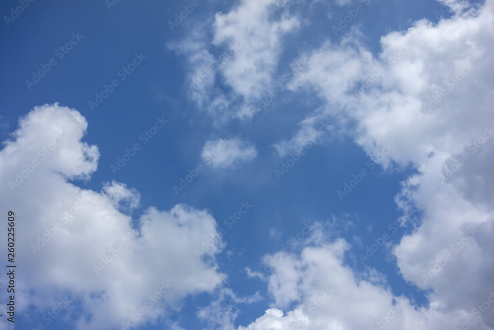 White clouds of bizarre shape run across blue sky creating beautiful unique look. Nature concept for design. White clouds of bizarre shape run across blue sky creating beautiful unique look. Nature concept for design.