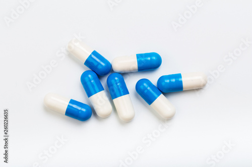 set of blue and white capsules on a white background