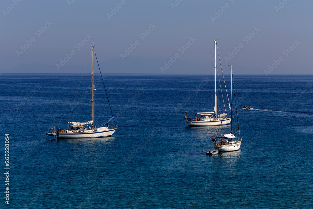 The yacht sails moored on the open sea (region of Epirus, Greece)