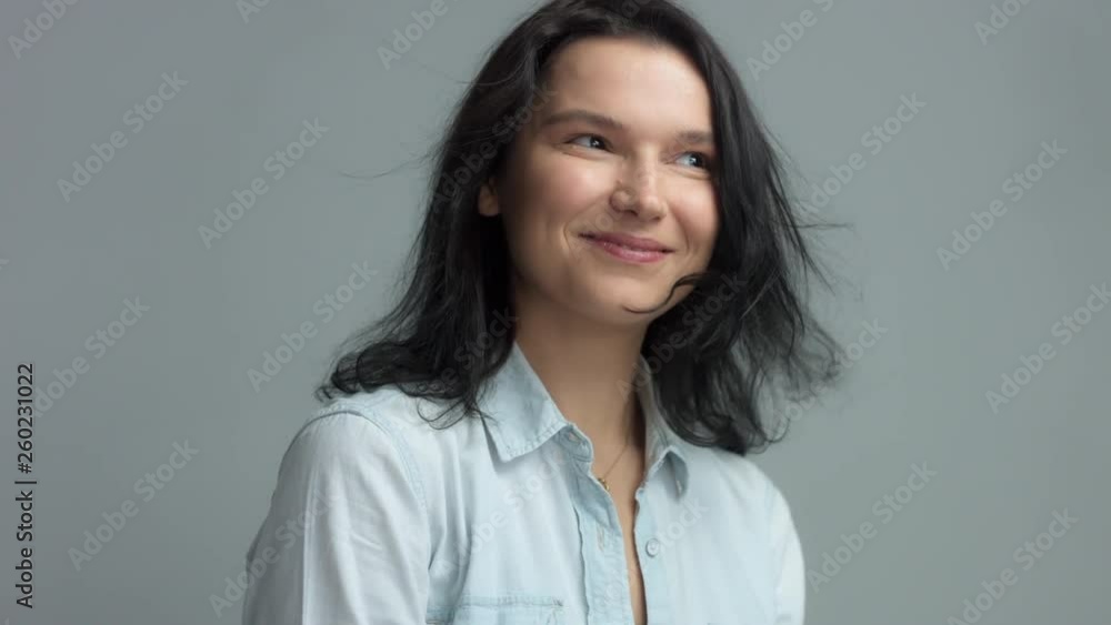 Brunette in studio portrait video shoot wwears jeans shirt with blowing hair slow motion from 60 fps Happy smiling laughing woman Brunette in studio portrait video shoot wwears jeans shirt with blowing hair slow motion from 60 fps Happy smiling laughing woman