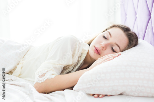 Beautiful young girl sleeping in her bed in the morning. health and beauty