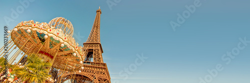 Vintage carousel and the Eiffel tower, Paris France panoramic background with copy space © Delphotostock