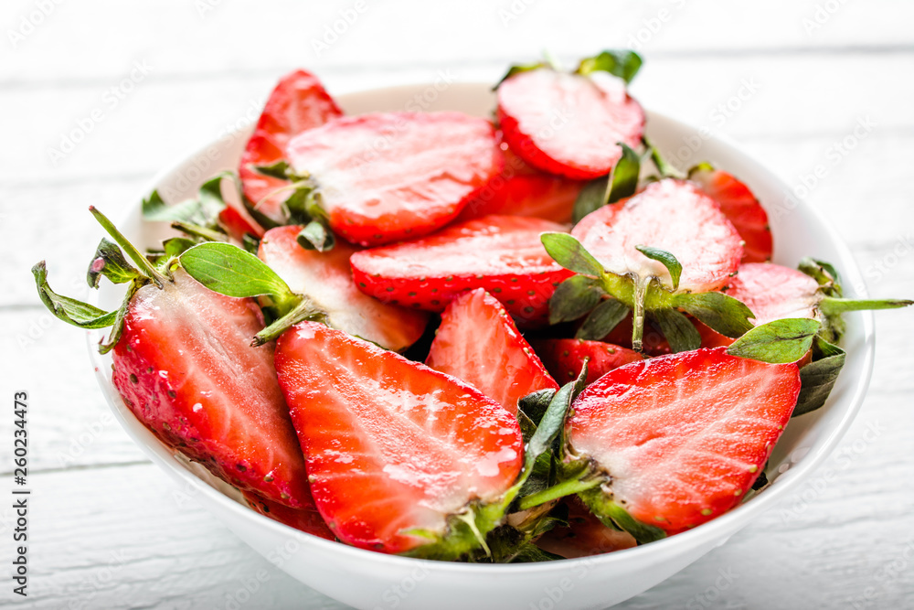 Fresh strawberries. Plate with juicy strawberry slices.