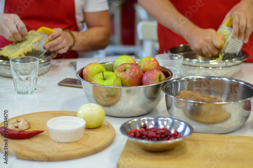 Fresh apples and other ingredients for cooking dishes are placed on the table