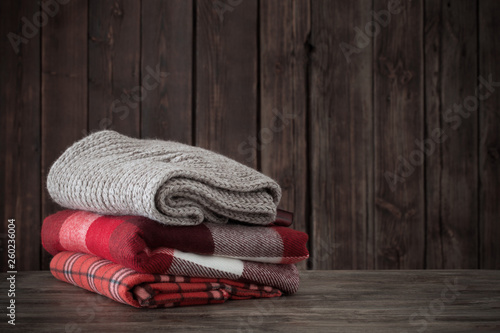 stack of plaids on wooden background photo