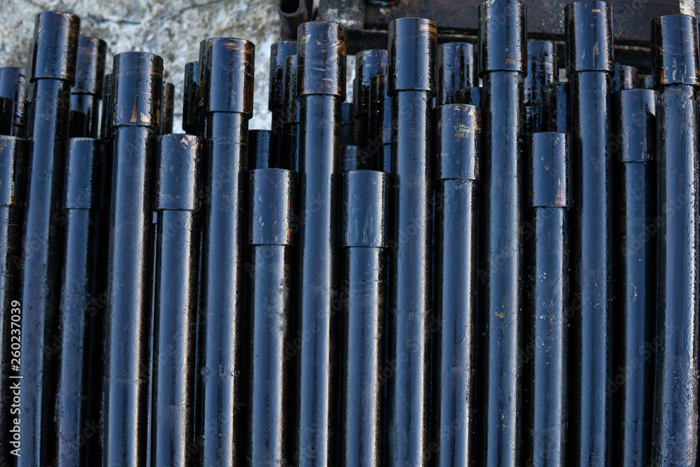 Pipe metal texture. Drillpipe on Oil Rig Pipe Deck. Rusty drill pipes were drilled in the well section. Pipe metal texture. Drillpipe on Oil Rig Pipe Deck. Rusty drill pipes were drilled in the well section.
