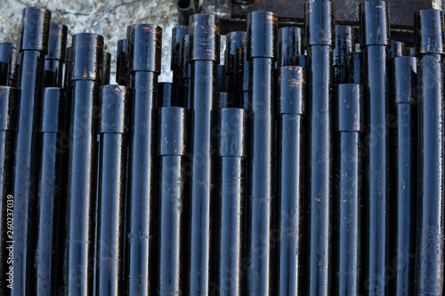 Pipe metal texture. Drillpipe on Oil Rig Pipe Deck. Rusty drill pipes were drilled in the well section.
