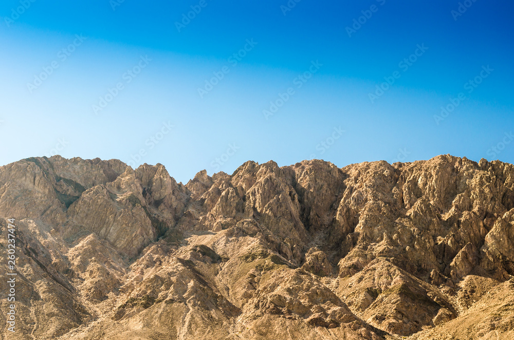 high rocky mountains against a clear blue sky