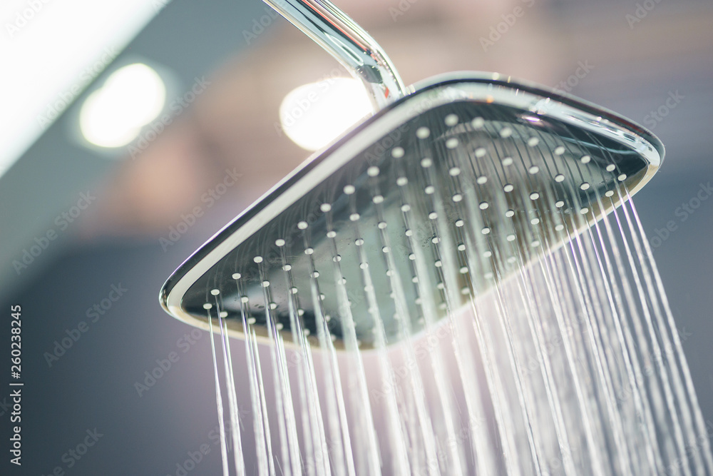 Water pours from the modern shower. Jets of water in the shower close-up. Water pours from the modern shower. Jets of water in the shower close-up.