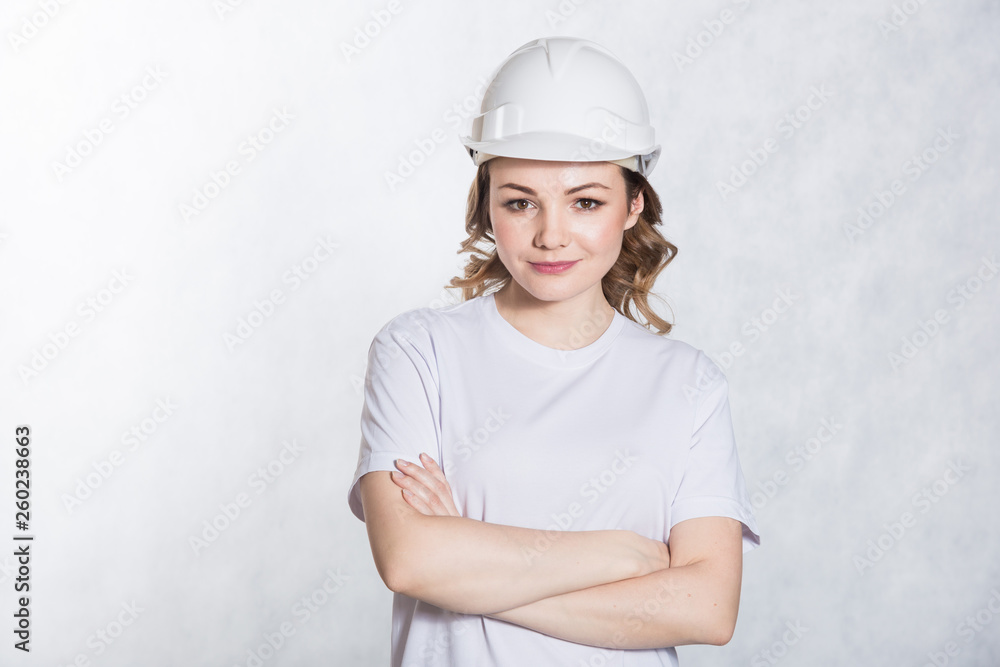 Young architect woman in white safety helmet hardhat on white background. Young architect woman in white safety helmet hardhat on white background.