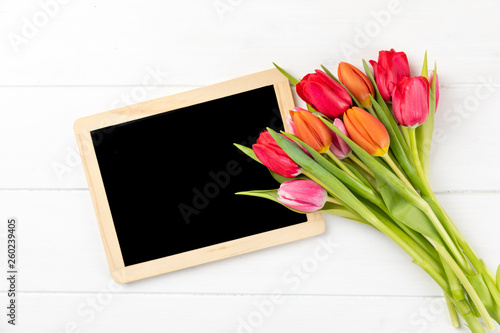 colorful tulips with chalkboard with copy space