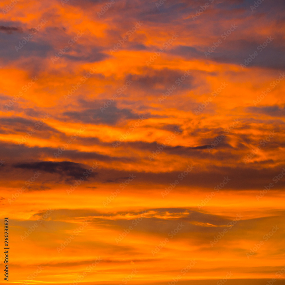 Fototapeta premium colorful orange cloudscape in evening dawn sky at sunset