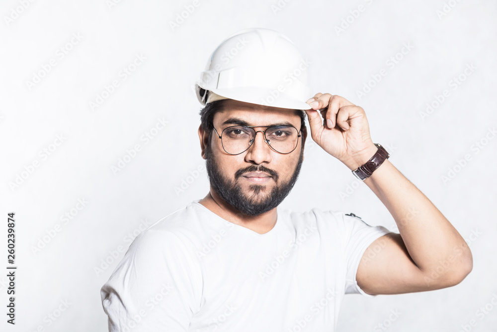 Young builder engineer with glasses and a white protective helmet. Young builder engineer with glasses and a white protective helmet.