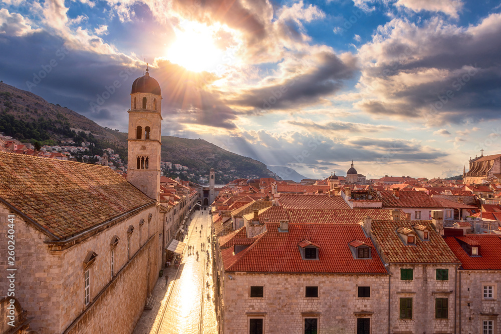 Old City of Dubrovnik red roofs and Stradun main street, top view from ancient city wall. World famous and most visited historic city of Croatia, UNESCO World Heritage site, travel background