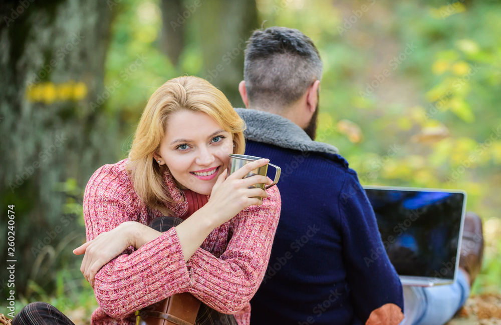 couple in love relax in autumn forest with laptop. camping and hiking. happy girl drink hot coffee or wine. man sit with back. Spring Family picnic. Relationship. Our work is amazing. work everywhere couple in love relax in autumn forest with laptop. camping and hiking. happy girl drink hot coffee or wine. man sit with back. Spring Family picnic. Relationship. Our work is amazing. work everywhere