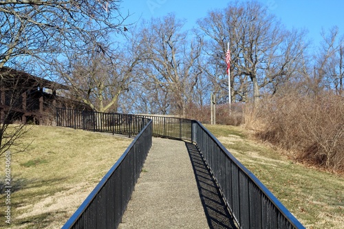 The walkway up the slope to the building in the park.