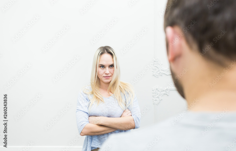 Unhappy young couple quarreling in the living room. Unhappy young couple quarreling in the living room.