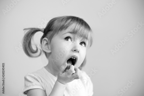 funny two years old girl with two cute pigtails  quiff and open mouth