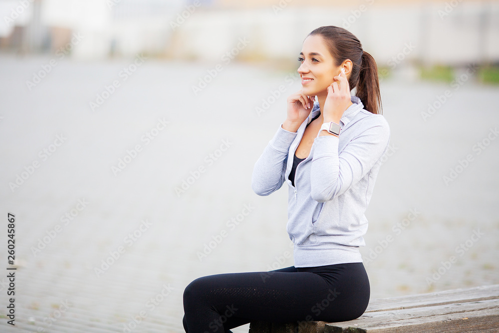 Fitness Girl. Portrait of a lovely young fitness girl listening music Fitness Girl. Portrait of a lovely young fitness girl listening music
