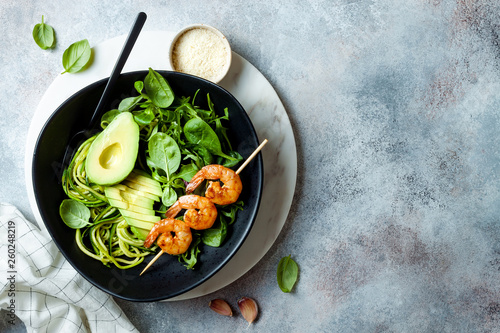 Photography Detox Buddha bowl with avocado, spinach, greens, zucchini noodles, grilled shrimps and pesto sauce