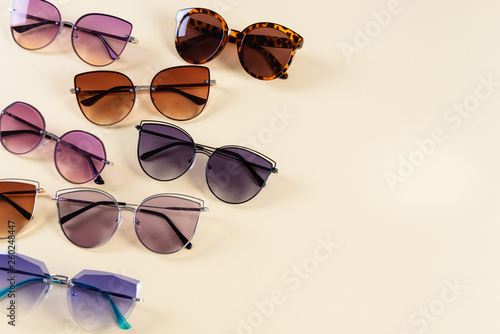 Different sunglasses on yellow background. Summer banner. Copy space. Optic shop photo