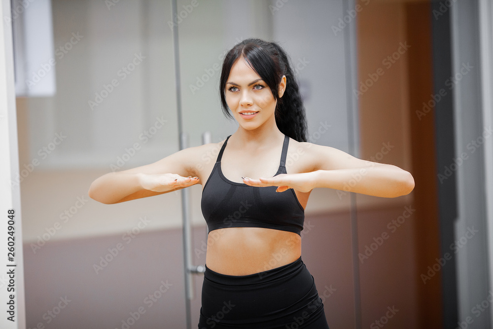 Fitness Girl. Sexy athletic girl working out in gym. Fitness woman doing exercise