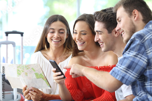 Group of tourists planning travel online on phone
