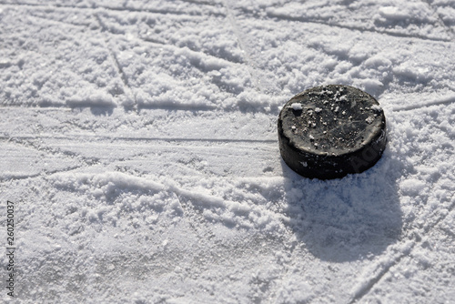 hockey puck lies on the ice in the stadium