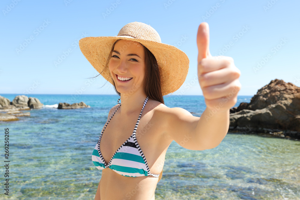 Happy tourist on the beach gesturing thumb up