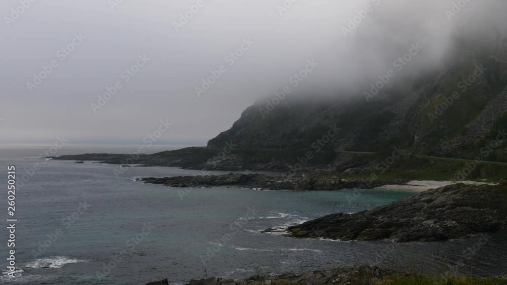 Coast of Gimsoya island in summertime. Sea with mountains. Nordland county, Lofoten archipelago Norway. Tourist attraction Coast of Gimsoya island in summertime. Sea with mountains. Nordland county, Lofoten archipelago Norway. Tourist attraction