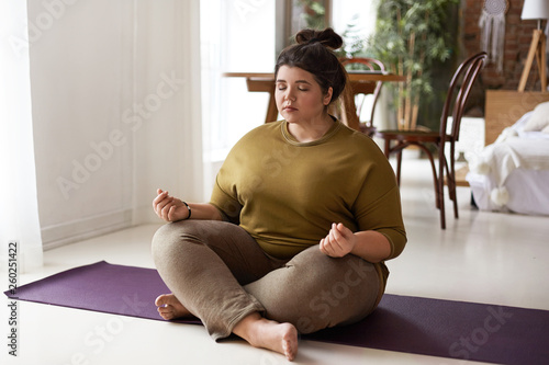 Obraz na plátně Young woman meditating at home