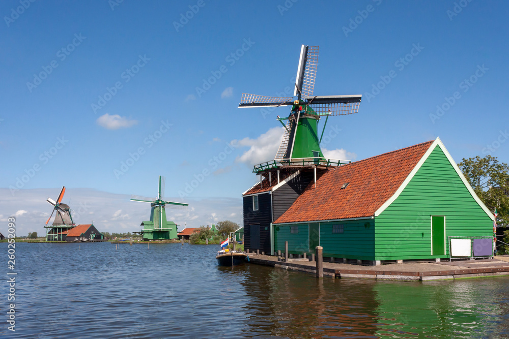 Dutch green sawmill at the edge of river facing the wind and reading for servicing