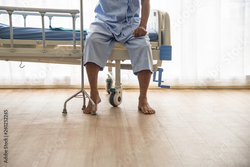 The sick Asian old man couldn't walk sitting alone with walking stick in the hospital or healthcare
