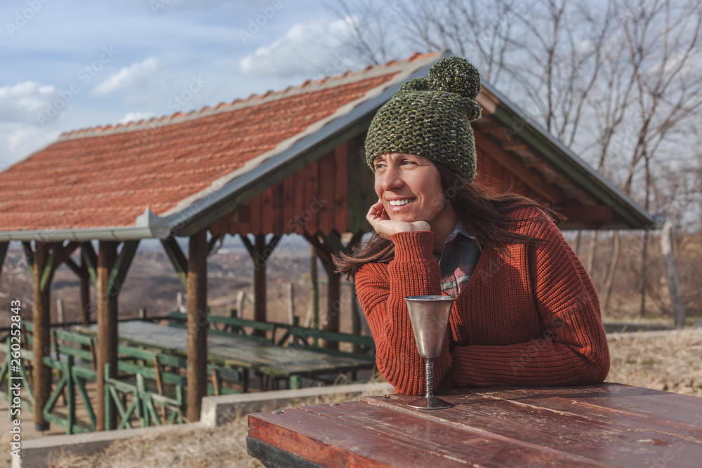 Obraz premium Beautiful woman enjoying in a sunny autumn day