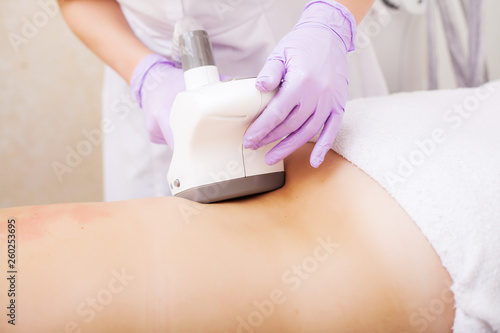Body Care. Woman is in the process at the clinic lipomassage