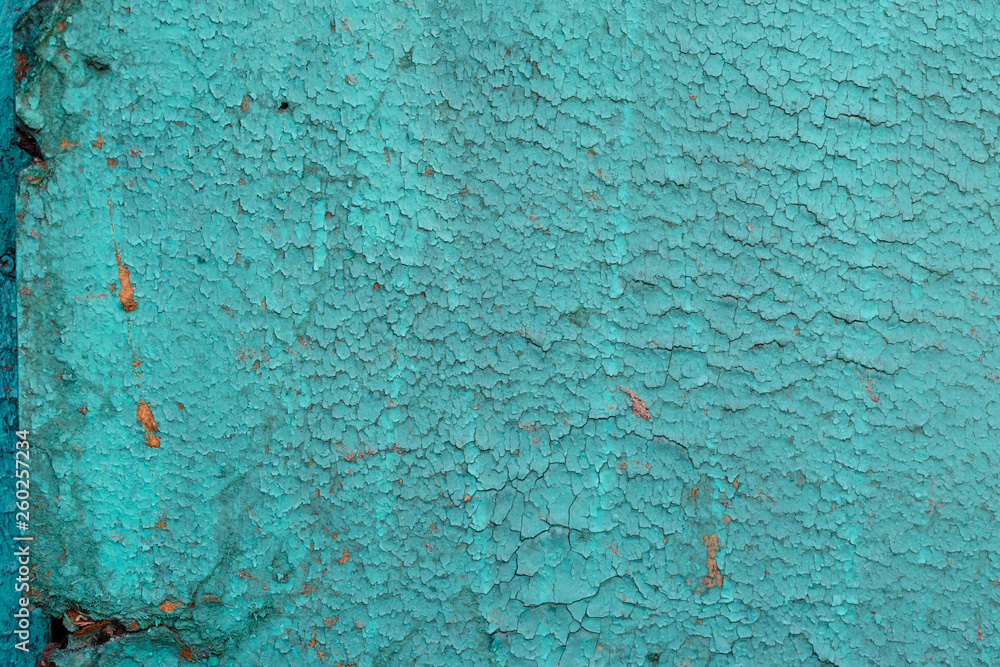 Textured background cracked turquoise paint.