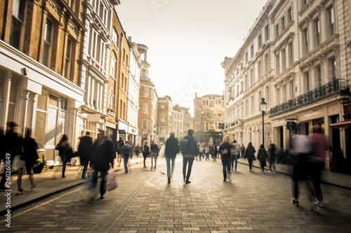Fototapeta Naklejka Na Ścianę i Meble -  People on a shopping street in motion blur
