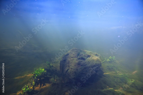 sunbeams underwater photo / texture underwater landscape with sun rays, blue water sun in the ocean © kichigin19
